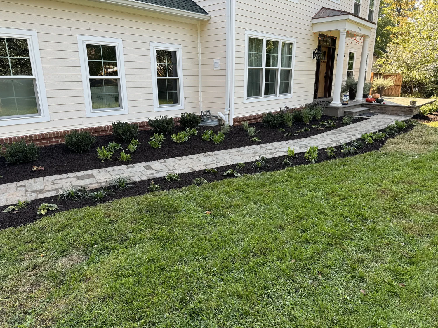 A stone walkway and landscaped lawn.